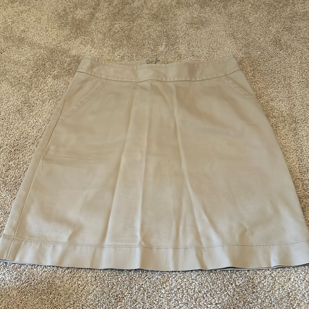 Banana Republic brand, women’s tan colored skirt with zipper in the back.